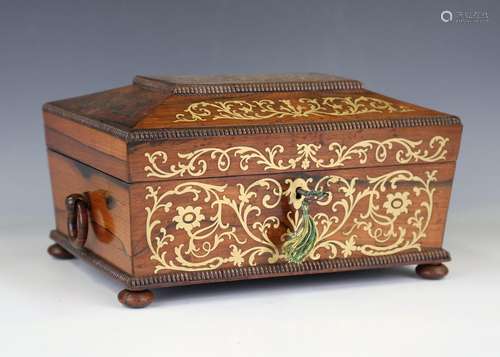 A Regency rosewood and brass inlaid sewing box of sarcophagu...