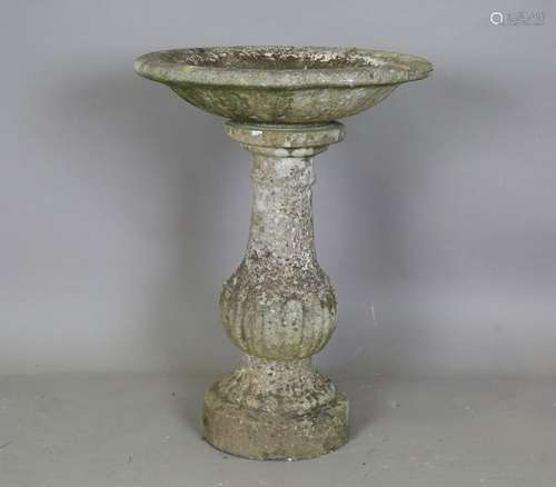 A 20th century cast composition stone birdbath with dished b...