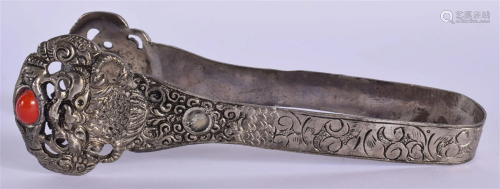 A PAIR OF EARLY 20TH CENTURY TIBETAN WHITE METAL TONGS inset...
