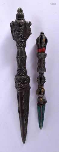 A TIBETAN BRONZE PHURBA and another. 21 cm long. (2)