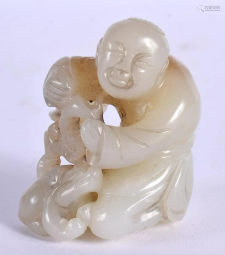 A CHINESE CARVED WHITE JADE FIGURE OF A BOY 20th Century. 5....