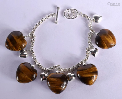 A CHINESE CARVED TIGERS EYE BRACELET 20th Century. 38 grams....