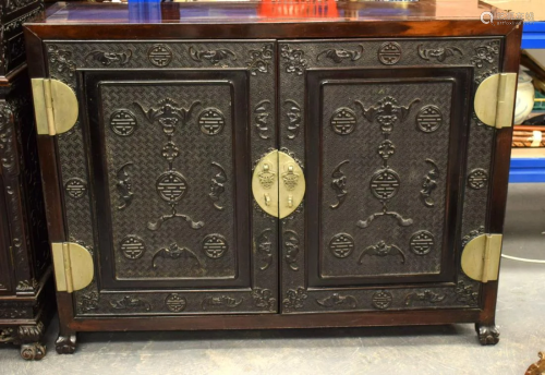 A 19TH CENTURY CHINESE CARVED HONGMU TWO DOOR SIDEBOARD Qing...