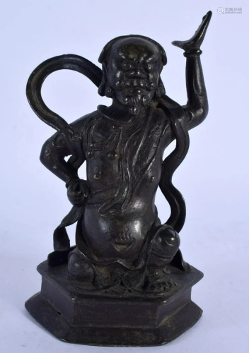 A 17TH/18TH CENTURY CHINESE BRONZE FIGURE OF A SEATED GUARDI...