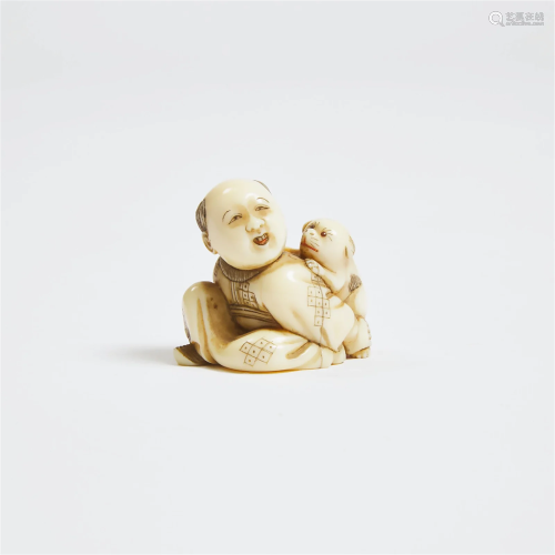 A Netsuke of a Boy Holding a Puppy, Signed Yoshiyuki, Late