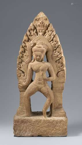 A beige sandstone antefix or pediment of a dancing figure. C...