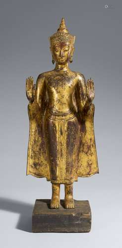 An Ayutthaya gilt and lacquered bronze figure of a crowned B...