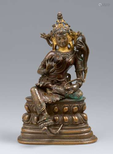 A Tibetan bronze figure of Syamatara with cold gold and pigm...