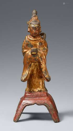 A lacquered and gilt bronze figure of a female attendant. Mi...