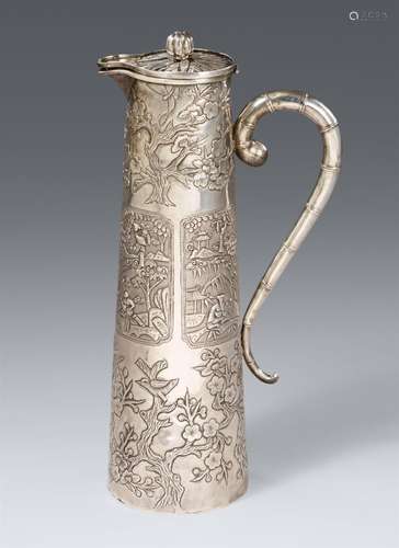 An elongated silver hot water ewer. Around 1900