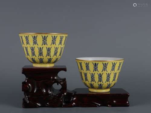 A PAIR OF YELLOW BASED BLUE-SPLASHED CUPS