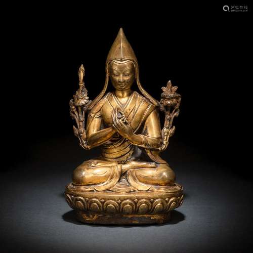 A GILT-BRONZE FIGURE OF SEATED TSONKHAPA ON A LOTUS