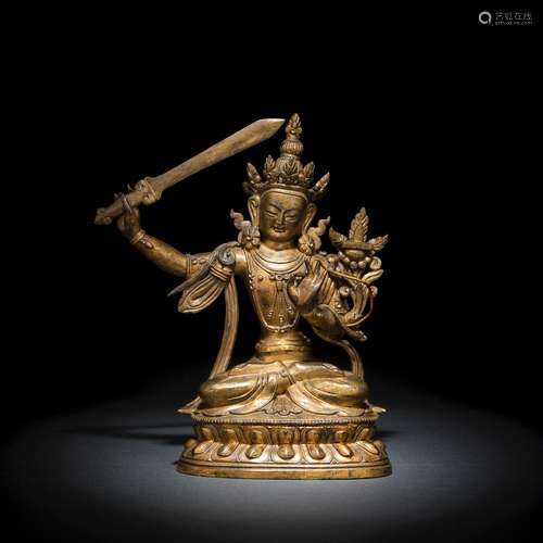 A GILT-BRONZE FIGURE OF SEATED MANJUSHRI