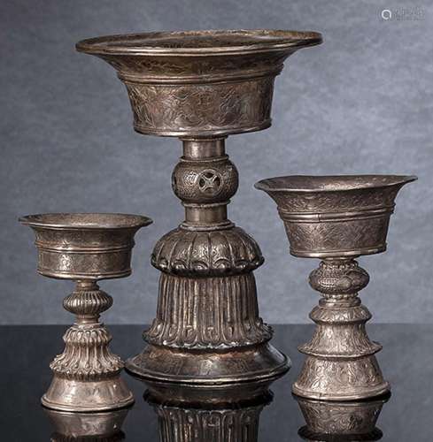 A GROUP OF BUTTER LAMPS, PARTLY WORKED IN SILVER