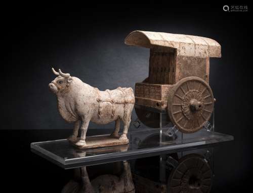 A COLD PAINTED GREY EARTENWARE MODEL OF AN OX AND CART MOUNT...