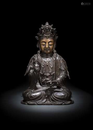 A BRONZE FIGURE OF SEATED GUANYIN WITH REMNANTS OF GILDING