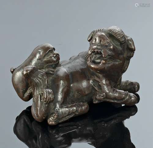 A BRONZE PAPER WEIGHT IN SHAPE OF A RECUMBENT LION AND IT&#x...