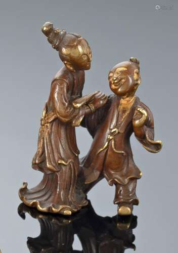 A R-BRONZE WEIGHT IN SHAPE OF A BOY AND LADY WITH REMNANTS O...