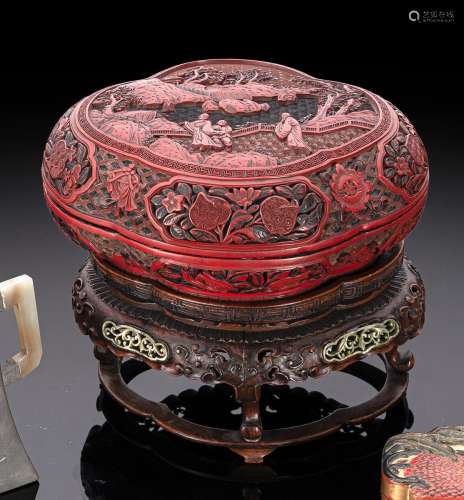A WELL CARVED CINNABAR LACQUER BOX AND COVER ON ORIGINAL STA...