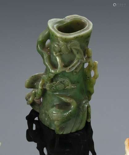 A SPINACH-GREEN FINELY CARVED TREE TRUNK PINE VASE WITH CRAN...