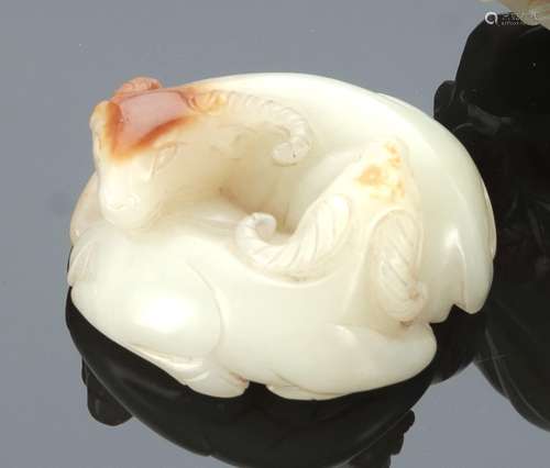 A LIGHT-GREEN AND CARAMEL JADE GROUP OF TWO RAMS