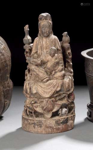 A CARVED AND PAINTED WOOD MODEL OF SEATED GUANYIN AND BOY WI...