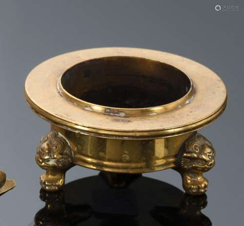 A SMALL GOLD-COLORED BRONZE CENSER ON THREE SHORT FEET