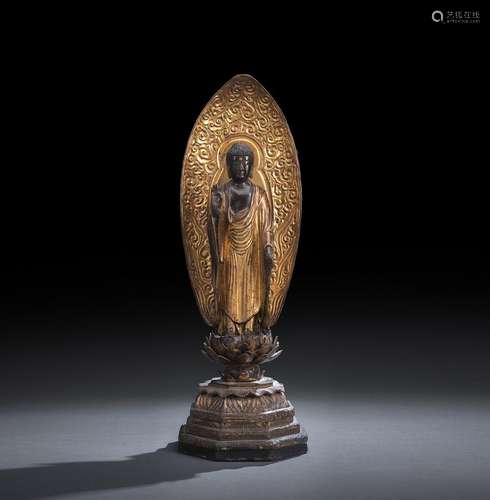 A LACQUERED AND PART-GILT WOOD FIGURE OF AMIDA STANDING ON A...