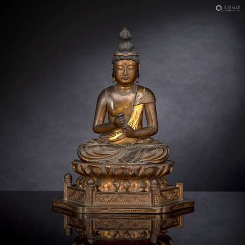 A LACQUERED AND GILT WOOD FIGURE OF KANNON BOSATSU ON A LOTU...