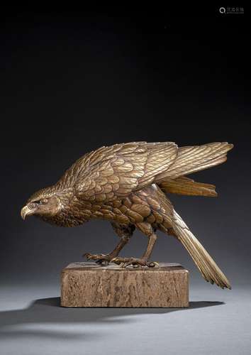 A GILT-BRONZE MODEL OF AN EAGLE ON A TRAVERTINE PLINTH