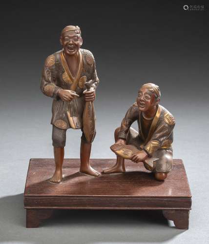 A PART-GILT BRONZE GROUP OF TWO FISHERMEN WITH FISHES IN THE...