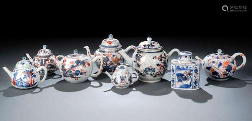 A GROUP OF SEVEN IMARI TEAPOTS AND COVERS AND A TEA CADDY