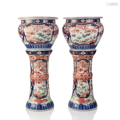 A pair of porcelain cachepots with matching stands with flor...