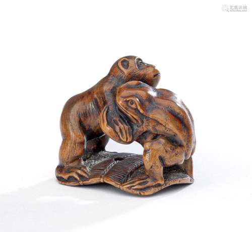 AN OKIMONO-TYPE WOOD NETSUKE OF A MONKEY AND A TOAD WRESTLIN...