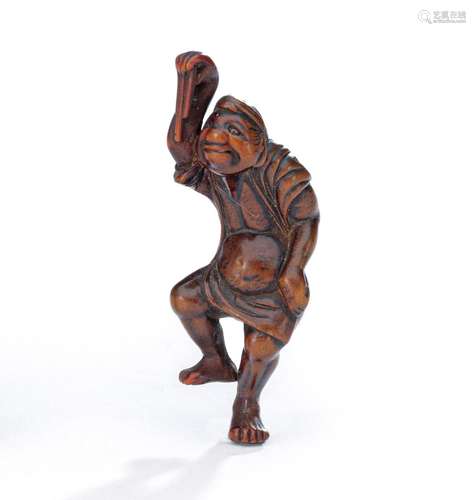 A CARVED BOXWOOD NETSUKE OF A CRANE DANCER