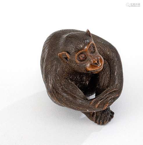 A CARVED-WOOD NESTUKE OF A SEATED MONKEY