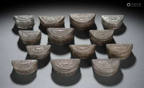 A GROUP OF SEMICIRCLE-SHAPED SILVER BOXES