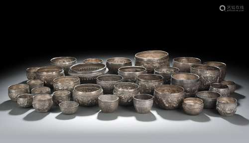 A GROUP OF SILVER AND METAL RELIEF BOWLS