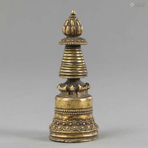 A SMALL GILT-BRONZE STUPA