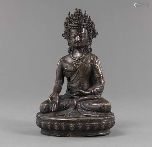 A BRONZE FIGURE OF CROWNED BUDDHA IN BHUMISPARSHA MUDRA