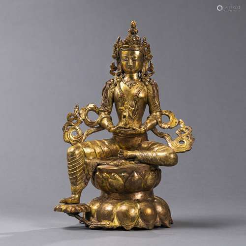 A GILT-BRONZE FIGURE OF TARA ON A LOTUS PEDESTAL