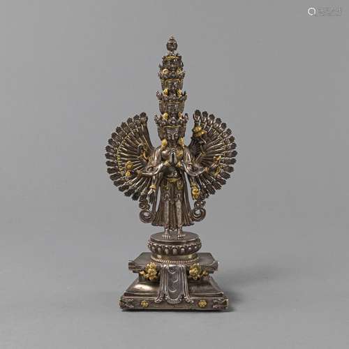 A PART-GILT SILVER FIGURE OF THOUSAND-ARMED AVALOKITESHVARA