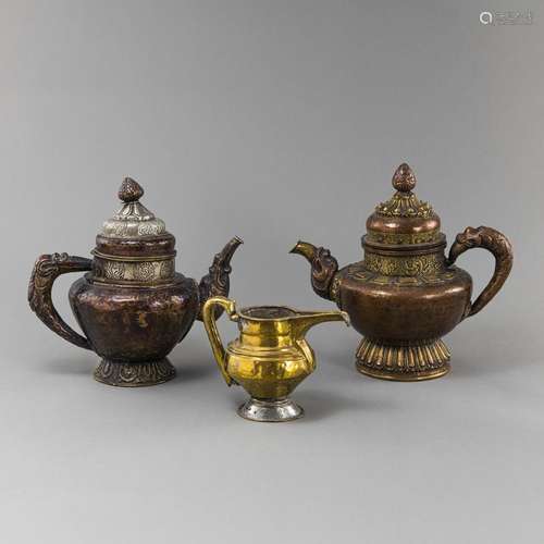 THREE PARCEL-GILT COPPER EWERS