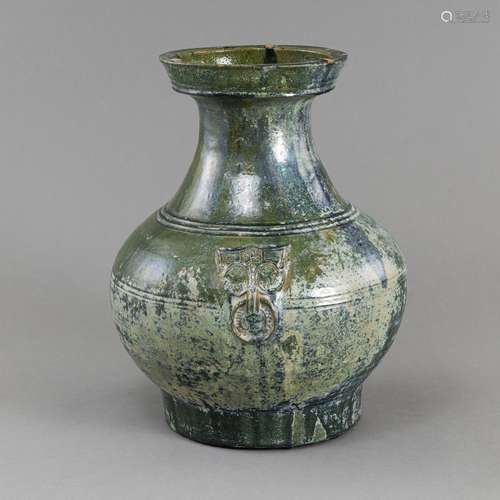 A GREEN GLAZED STONEWARE 'HU' VASE WITH MASK HANDL...