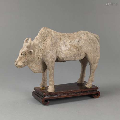 A POTTERY FIGURE OF A BULL