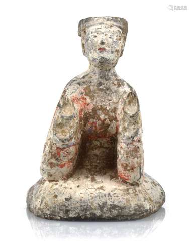 A PAINTED POTTERY FIGURE OF A KNEELING MAN