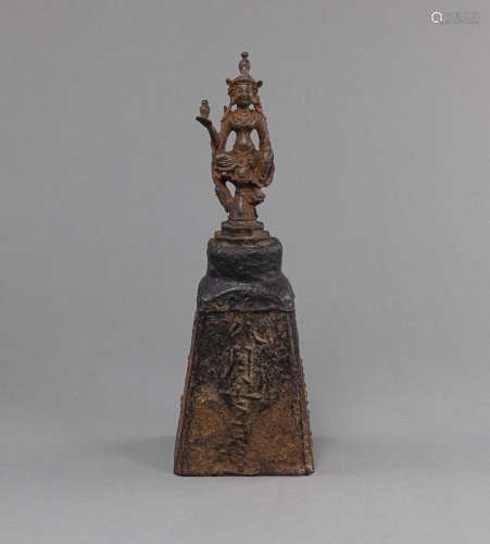 AN INSCRIBED IRON WEIGHT WITH A BODHISATTVA AS A HANDLE