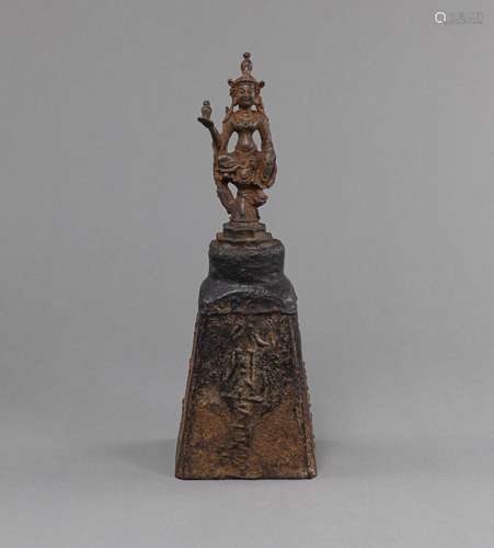 AN INSCRIBED IRON WEIGHT WITH A BODHISATTVA AS A HANDLE