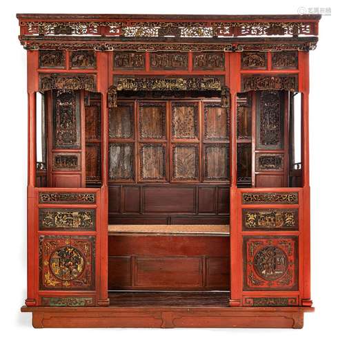 AN ALCOVE BED WITH PARTIALLY GILT OPENWORK RELIEF WOOD PANEL...