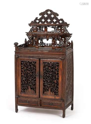 A CARVED WOOD CABINET WITH TEN DRAWERS